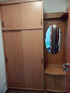 a bathroom with a wooden door and a mirror at Bibi Apartment in Martin