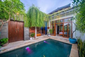 a pool in the backyard of a house with trees at Cheerful Private 1Br HoneyMoon Villa BlueLove Seririt in Banjar