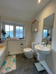 a bathroom with a sink and a toilet and a tub at Rose Cottage 