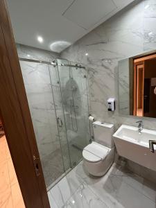 a bathroom with a shower and a toilet and a sink at Twin Hotel Tanger in Tangier