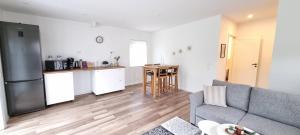 a living room with a couch and a kitchen at Stenhuset in Linköping