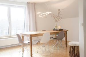 a dining room with a wooden table and chairs at Haus129 in Borkum