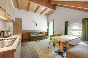 a kitchen with a table and a living room at Alpenaussicht in Obergurgl