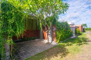 a small tree in front of a house at Cheerful Private 1Br HoneyMoon Villa BlueLove Seririt in Banjar