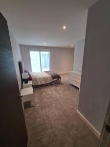 a bedroom with a bed and a window at Rent Luxuri - Luxury 2 bed Apartment in Leicester