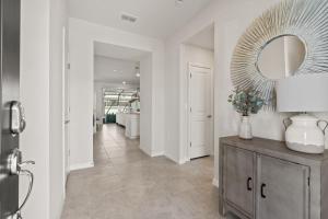 a hallway of a home with a mirror on the wall at NEW to Market New Construction 5 Bed Retreat In World Famous Windsor Island in Davenport