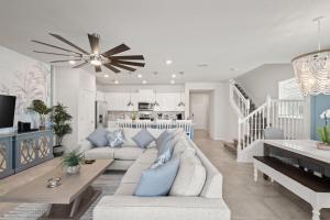 a living room with a couch and a ceiling fan at NEW to Market New Construction 5 Bed Retreat In World Famous Windsor Island in Davenport