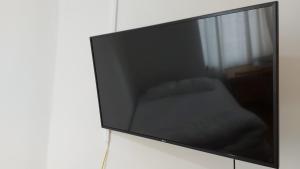 a flat screen tv sitting on a wall at Love & Travel in Dublin