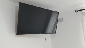 a flat screen tv hanging on a wall at Love & Travel in Dublin