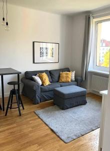 a living room with a couch and a table at Cute Apartment In The City Center , 2-Beds , Wi-Fi - by HIK Apartments in Warsaw