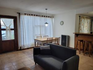 a living room with a couch and a table at Complejo Puente viejo JMT in Trevelín