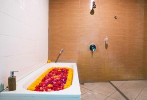 a bath tub filled with colorful flowers in a bathroom at Ubud Tropical Garden in Ubud +29 photos