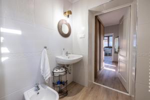 a white bathroom with a sink and a toilet at Apartament u Majerczyka in Zakopane +10 photos