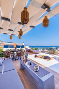 a living room with a view of the ocean at To Nissi in Skopelos Town