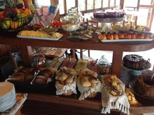 a table with a bunch of different types of food at POUSADA ELOHIM DE BUZIOS in Búzios +21 photos