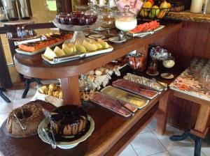 a buffet with many different types of food on a table at POUSADA ELOHIM DE BUZIOS in Búzios