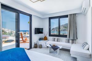 a hotel room with a view of the ocean at To Nissi in Skopelos Town