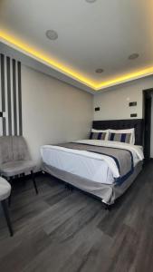 a bedroom with a large bed and a chair at SAND DOOR HOTEL in Istanbul