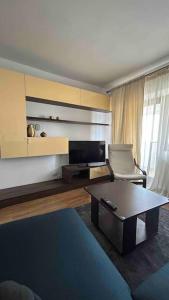 a living room with a couch and a coffee table at Georgiana’s central apartment in Buzău