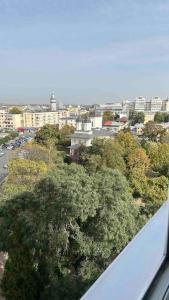 uma vista para uma cidade com edifícios e árvores em Georgiana’s central apartment em Buzău