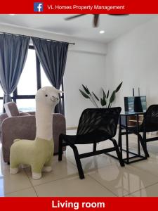 a living room with a stuffed sheep in a living room at Cozy 2room 7pax, Menara Sentral in Bukit Mertajam