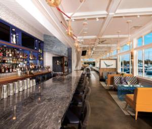 a bar with a long counter in a restaurant at The Hotel at Cape Ann Marina in Gloucester