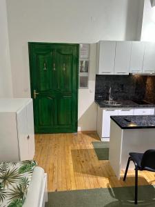 a green door in the middle of a kitchen at Guesthouse Hurma Rooms in Sarajevo