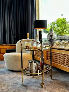 a glass table with a bottle of wine and a lamp at Landhotel Bellevue in Wolfshausen