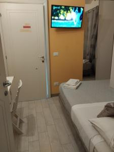 a bedroom with a bed and a tv on the wall at Da lea affitta camere in Bologna