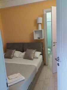 a bedroom with a bed with a yellow wall at Da lea affitta camere in Bologna