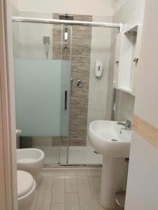 a bathroom with a shower and a toilet and a sink at Da lea affitta camere in Bologna