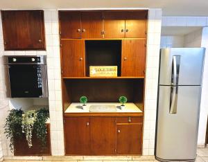 a kitchen with wooden cabinets and a refrigerator at Casa en la mejor ubicación! in Mendoza