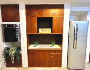 a kitchen with wooden cabinets and a refrigerator at Casa en la mejor ubicación! in Mendoza