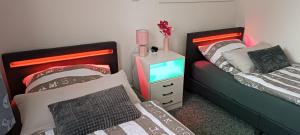 a bedroom with two beds and a tv in it at Ferienwohnung Auetal 