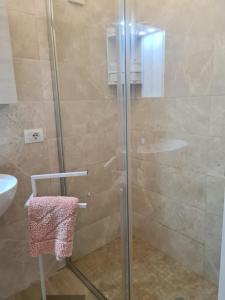 a shower with a glass door in a bathroom at Casa del papà in Noto +2 photos