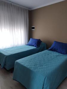 Una cama o camas en una habitación de Rosana Mariel