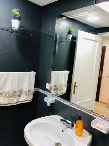 a bathroom with a sink and a mirror at Amazing Appartement au centre ville en face HILTON & Gare Train de TGV de TANGER in Tangier