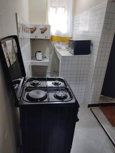 a kitchen with a stove top in a room at consortium apartments in Bungoma