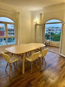 a dining room with a wooden table and chairs at Bright Homestay - New Cairo in Cairo +5 photos