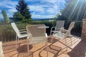 a group of chairs and a table on a patio at Villa Maison de campagne 04 Vacheres Luberon 3 chambres 8 personnes in Vachères