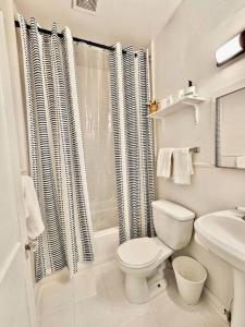 La salle de bains blanche est pourvue d'une douche et de toilettes. dans l'établissement Cool and calm place to live, à Memphis
