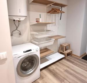 a laundry room with a washing machine in it at Entire Apartment + 2 Rooms + Self Check-in in Tallinn