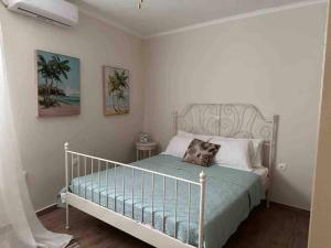 - une chambre avec un lit avec un cadre de lit en métal dans l'établissement kalos house, à Karpathos