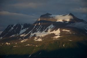 a mountain covered in snow and clouds in the sky at 3ART recreation in Tromsø