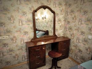 a bathroom with a vanity with a mirror and a stool at 2-к квартира Малиновського 12. Набережна лівого берега. in Dnipro