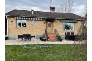 a house with a patio in front of it at Stuga i Kristdala Oskarshamnsvägen 39 in Kristdala