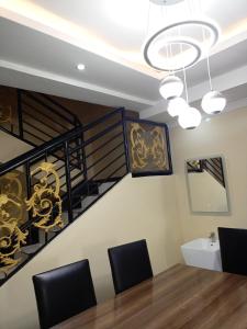 a dining room with a spiral staircase and a table and chairs at Kigali Peace villa in Kigali