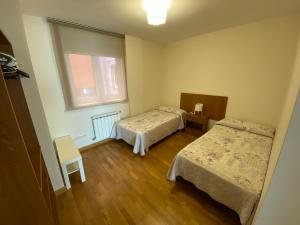מיטה או מיטות בחדר ב-dp Calvo Sotelo 164, 4D