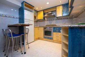 a kitchen with a counter and stools in it at Casa Manuel in Alcañiz