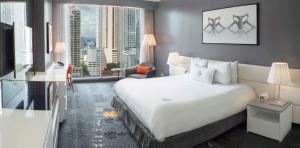 a hotel room with a large bed and a large window at Sortis Hotel, Spa & Casino, Autograph Collection in Panama City